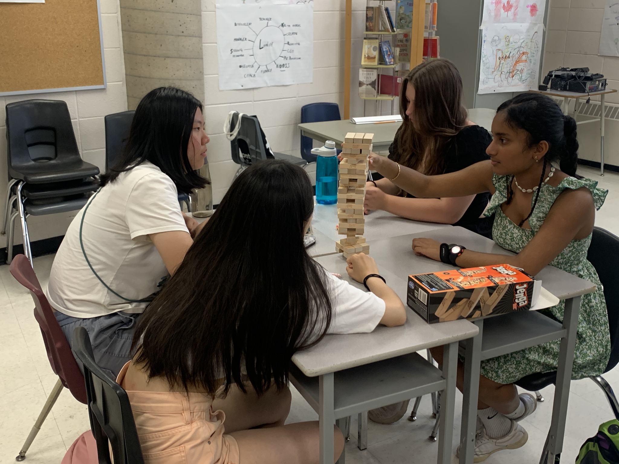 Students sitting at a table playing Jenga Open Gallery
